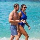 Zara McDermott – Wearing blue swimsuit on the beach in Barbados - 454 x 413