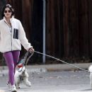 Lucy Hale – Wears a pair of purple leggings on a hike with her pooches in Los Angeles