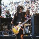 Jimmy Page performing at the Day on the Green at Oakland–Alameda County Coliseum in Oakland on July 23, 1977 - 454 x 654