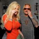 Musician Vince Neil (L) and wife Lia Gherardini pose in the Official Silver Spoon Gifting Lounge held during the 2008 American Music Awards at the Nokia Theatre on November 22, 2008 in Los Angeles, California - 454 x 421