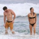Gabriella Brooks in Black Bikini and Liam Hemsworth on the beach in Byron Bay - 454 x 321