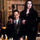 Anjelica Huston and Raul Julia