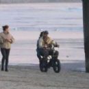 Kelly Gale – With Joel Kinnaman on the beach riding a Super73 electric bicycle in Venice - 454 x 302