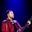 Chris Wolstenholme of Muse performs onstage during KROQ Almost Acoustic Christmas 2017 at The Forum on December 9, 2017 in Inglewood, California - 442 x 600