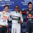 Pole sitter Lewis Hamilton (C) of Great Britain and Mercedes GP celebrates in parc ferme with second placed Sebastian Vettel (L) of Germany and Infiniti Red Bull Racing and third placed Mark Webber (R) of Australia and Infiniti Red Bull Racing following q - 454 x 303