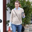 'How I Met Your Mother' star Alyson Hannigan braves the rain to pick up a cup of coffee and shop at Poppy store in the Brentwood Country Mart on October 9, 2013 in Brentwood, California