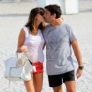 Claudia Galanti and french boyfriend Arnaud Mimran kissing beachside on Christmas day in Miami Beach