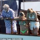 Queen's Roger Taylor uses a pole and shoots an AIRGUN at jellyfish whilst on a boat ride with his wife and children during sun-soaked holiday in Spain, 31 May 2019 - 306 x 283