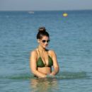 Amy Willerton – In a green bikini on the beach in Dubai - 454 x 315