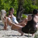 Kim Kardashian – With Khloe in a metallic swimsuits in Turks and Caicos