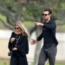 Josh Duhamel and Fergie look somber as they leave a funeral service