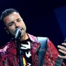 Chris Wolstenholme of Muse performs onstage during KROQ Almost Acoustic Christmas 2017 at The Forum on December 9, 2017 in Inglewood, California - 454 x 311