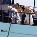 Queen's Roger Taylor uses a pole and shoots an AIRGUN at jellyfish whilst on a boat ride with his wife and children during sun-soaked holiday in Spain, 31 May 2019 - 306 x 479