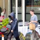 Jennifer Lawrence – In a large black coat while out to lunch with Andrew Barth Feldman in NY