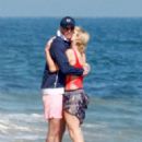 Paris Hilton – Wears a red swimsuit on the beach in Malibu
