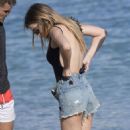Chloe Lloyd in Black Swimsuit on the beach in Mykonos - 454 x 681