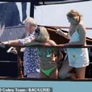 Queen's Roger Taylor uses a pole and shoots an AIRGUN at jellyfish whilst on a boat ride with his wife and children during sun-soaked holiday in Spain, 31 May 2019 - 306 x 283