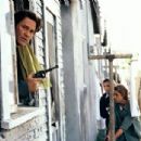 Detective Eldon Perry (Kurt Russell) leads Beth Williamson (Michael Michele, center) and Bobby Keough (Scott Speedman, right) in searching for a suspect