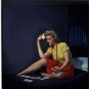 Woman in cell, playing solitaire, ca. 1950