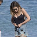 Chloe Lloyd in Black Swimsuit on the beach in Mykonos - 454 x 681