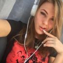 Viola Bailey (Violeta Jurgis Arturovna) without makeup listens to music with her headphones while wearing a Naruto T-Shirt - Instagram - August 17, 2018
