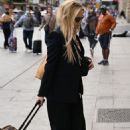 Kate Hudson wears a chic black suit worn over a vintage MTV T-shirt as she leaves Paris