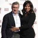 Robert De Niro and his wife Grace Hightower pose together at his hand and footprint ceremony at the TCL Chinese Theatre in Los Angeles on Feb. 4, 2013 - 454 x 595