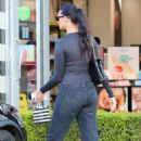 April Love Geary – Wearing a Lycra long sleeve shirt, ripped jeans and brown Nike Jordan in Malibu