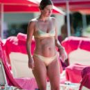 Rhea Durham in Gold Bikini on the beach in Barbados