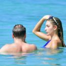 Zara McDermott – Wearing blue swimsuit on the beach in Barbados - 454 x 348