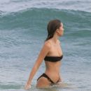 Gabriella Brooks in Black Bikini and Liam Hemsworth on the beach in Byron Bay - 454 x 564