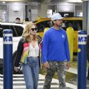 Heather Graham – With boyfriend John De Neufville as they arrive to Miami International Airport