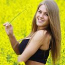 Viola Bailey (Violeta Jurgis Arturovna) in a yellow flower field - Instagram - February 23, 2017