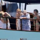 Queen's Roger Taylor uses a pole and shoots an AIRGUN at jellyfish whilst on a boat ride with his wife and children during sun-soaked holiday in Spain, 31 May 2019 - 454 x 327
