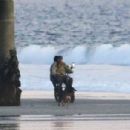Kelly Gale – With Joel Kinnaman on the beach riding a Super73 electric bicycle in Venice - 454 x 302
