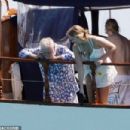 Queen's Roger Taylor uses a pole and shoots an AIRGUN at jellyfish whilst on a boat ride with his wife and children during sun-soaked holiday in Spain, 31 May 2019 - 454 x 303