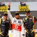 First placed Lewis Hamilton (C) of Great Britain and McLaren celebrates on the podium with second placed Kimi Raikkonen (L) of Finland and Lotus and third placed Romain Grosjean (R) of France and Lotus following the Hungarian Formula One Grand Prix at the - 454 x 303
