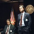 Kurt Russell and Scott Speedman (seated) star as Los Angeles policeman Eldon Perry and rookie Bobby Keough