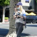 Suki Waterhouse – In grey leggings chats on her phone in Beverly Hills