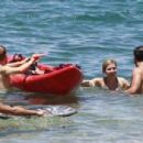 Jennette McCurdy wearing a pretty bikini and board shorts was spotted kayaking with a male friend in Maui