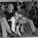 Veronica Lake, petite blond actress is shown here with her husband, Capt. John Detlie of the Army Engineers, stationed in Seattle.  The two sat side by side in Victory Square, where they were guests of honor