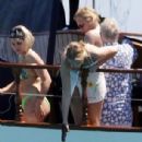Queen's Roger Taylor uses a pole and shoots an AIRGUN at jellyfish whilst on a boat ride with his wife and children during sun-soaked holiday in Spain, 31 May 2019 - 306 x 340