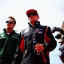 (L-R) Giedo van der Garde of the Netherlands and Caterham and Kimi Raikkonen of Finland and Lotus attend the drivers parade before the British Formula One Grand Prix at Silverstone Circuit on June 30, 2013 in Northampton, England