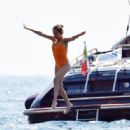 Penelope Cruz – In orange swimsuit on a yacht in Portofino