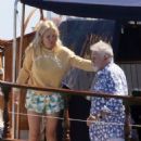 Queen's Roger Taylor uses a pole and shoots an AIRGUN at jellyfish whilst on a boat ride with his wife and children during sun-soaked holiday in Spain, 31 May 2019 - 454 x 554