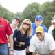 SANDRA BULLOCK as Leigh Anne Tuohy (center, sunglasses), PHILLIP FULMER (right center, orange hat) as himself and RAY McKINNON (right, white visor) as Coach Cotton in Alcon Entertainment's drama 'The Blind Side,' a Warner Bros. Pictures releas