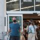 Dakota Johnson – With Chris Martin shopping together at Erewhon Market in Los Angeles