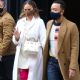 Chrissy Teigen – In thigh-high pink boots and a white dress out in New York