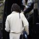 Anne Hathaway – Wearing a protective face mask while leaving a hotel in Milan