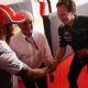 Lewis Hamilton (L) of Great Britain and McLaren shakes hands with Red Bull Racing Team Principal Christian Horner (R) as they attend an event to celebrate the 82nd birthday of F1 supremo Bernie Ecclestone (C) before the Indian Formula One Grand Prix at Bu
